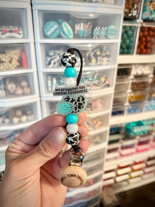 We go together like Cowhide and Turquoise Pacifier Holder