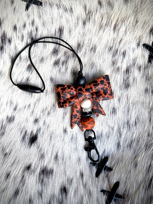 Rust Aztec Cowhide Bow Mirror Hanger