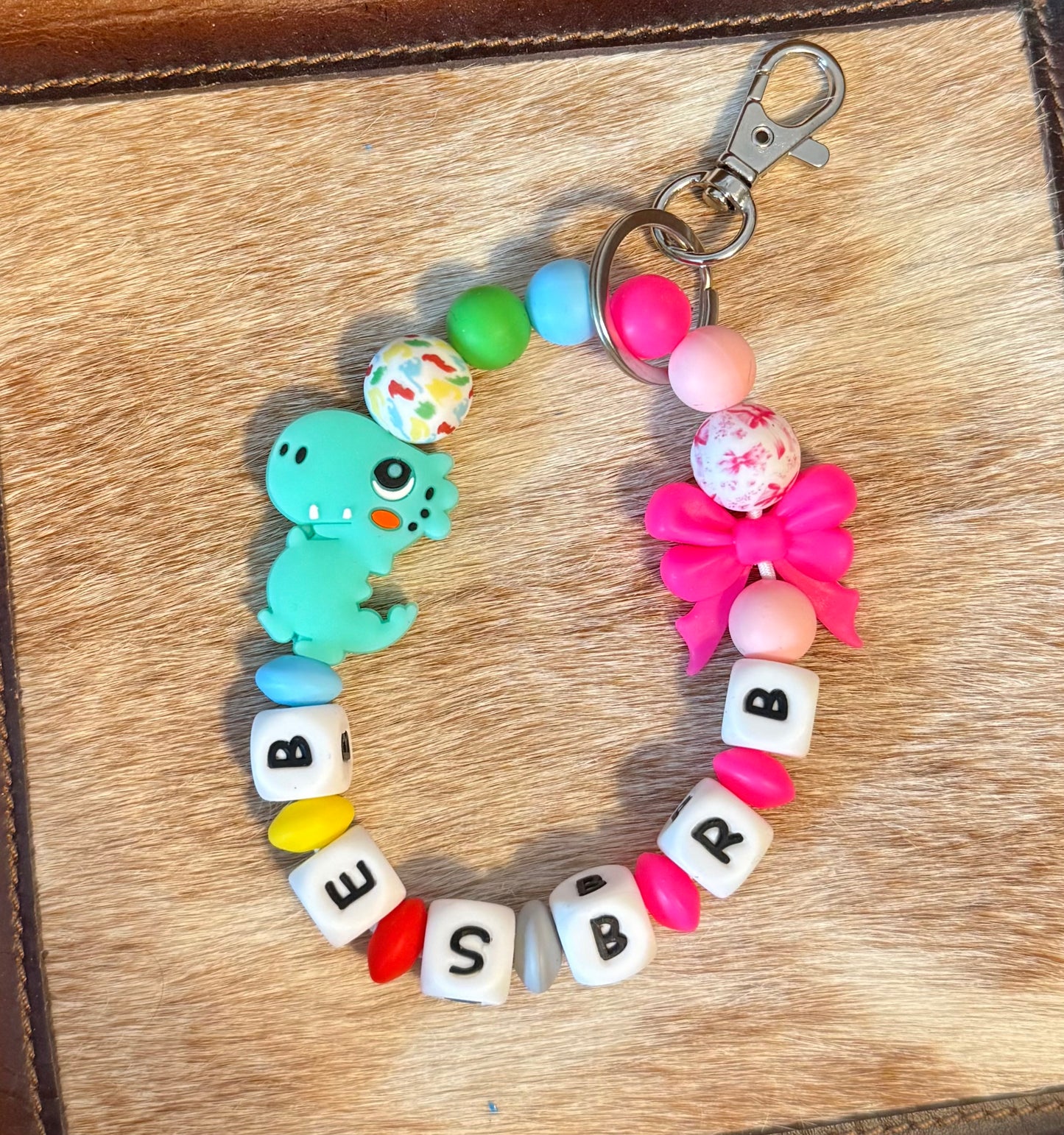 Mama of Both Bow and Dino Wristlet